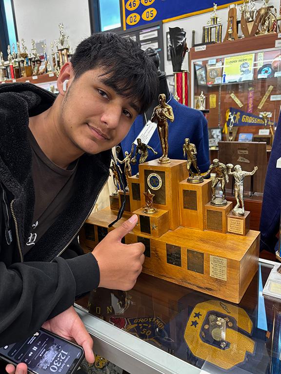 Freshman Kayden Padilla with his great great grandfather's trophy Bert Kohnhorst 1951-52 Track Runner