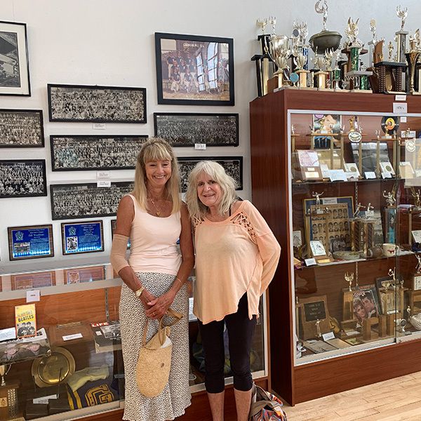 August 2021 Class of 1970 Terry Kennefick and Alexina Wempren in front of 1970s showcases